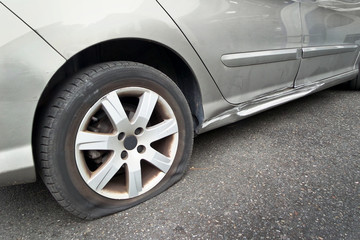 Close up of a flat rear tire on a car