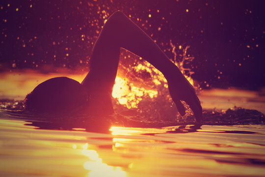 Swimming in sunset/sunrise.