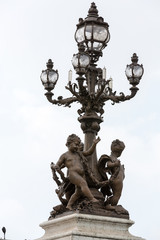 Fototapeta na wymiar Street lantern on the Alexandre III Bridge in Paris, France.