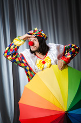 Obraz na płótnie Canvas Funny clown with colourful umbrella