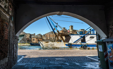 View to harbour from house arch, Chioggia,Italy.