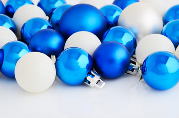 Blue and white christmas balls on the white background