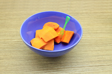 blue bowl with papaya as natural, fresh and sweet fruit