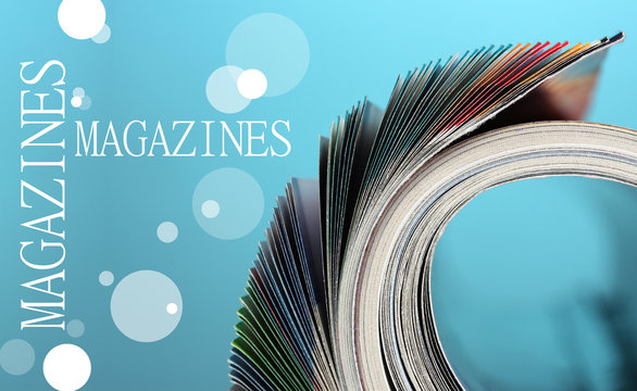 Rolled up magazines on blue background