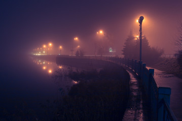 Fototapeta na wymiar City shore in fog. Night scene.