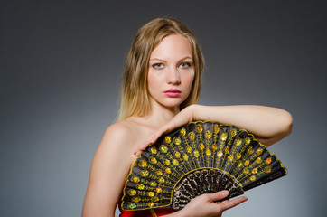 Woman dancing with fans in arts concept