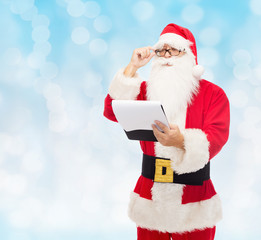 man in costume of santa claus with notepad