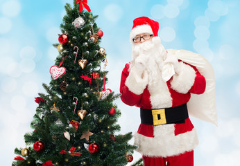 santa claus with bag and christmas tree