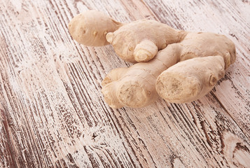 Ginger root sliced on wooden table