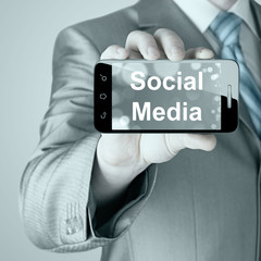 business man hand holding smartphone with Socail Media