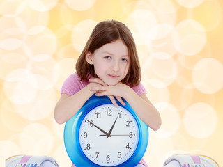 Little girl with a big clock.