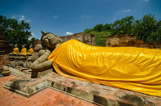 statue at reclining buddha in Wat Puthai Sawam Thailand
