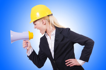 Fototapeta premium Female construction worker with loudspeaker