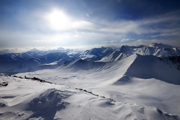 Naklejka na ściany i meble Snowy mountains and view on off-piste slope