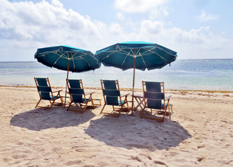 Two sun loungers on an empty beach.                             