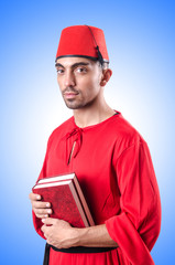 Young turk with book on white