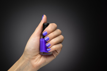 Beautiful manicure and polish is a violet color.