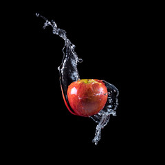 Red apple splashing into water
