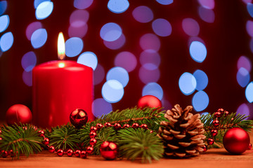 Red Christmas candle with pine cone decoration
