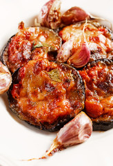 Grilled eggplant with tomatoes, garlic and melted cheese