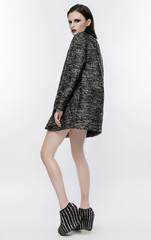 Fashion model in studio in modern outfit