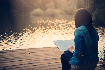 Girl reading on a pier