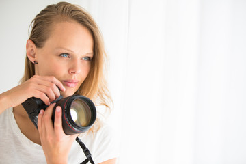 Fototapeta premium Pretty, female photographer with digital camera