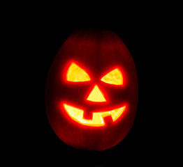 Halloween pumpkin jack-o-lantern candle lit, isolated on black