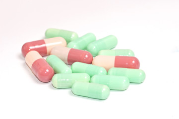 Colorful medical capsules on white background.