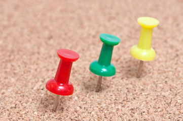 close up of a pushpin on cork board