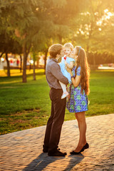 Happy family walking in park