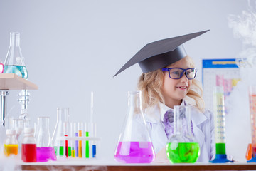 Image of cute surprised girl posing in laboratory