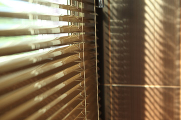 blinds in home with sunlight on the window