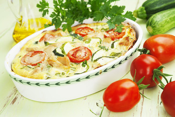 Zucchini baked with chicken, cherry tomatoes and herbs