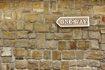 Fototapeta na wymiar One Way Arrow on Old Stone Wall