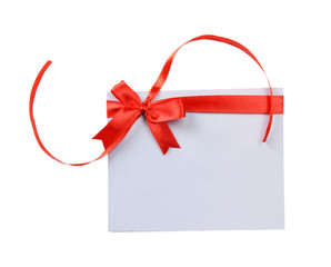 Shiny red ribbon with card isolated on white