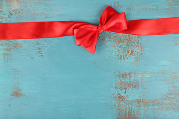 Old wooden background with beautiful bow