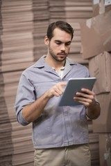 Warehouse worker using digital tablet