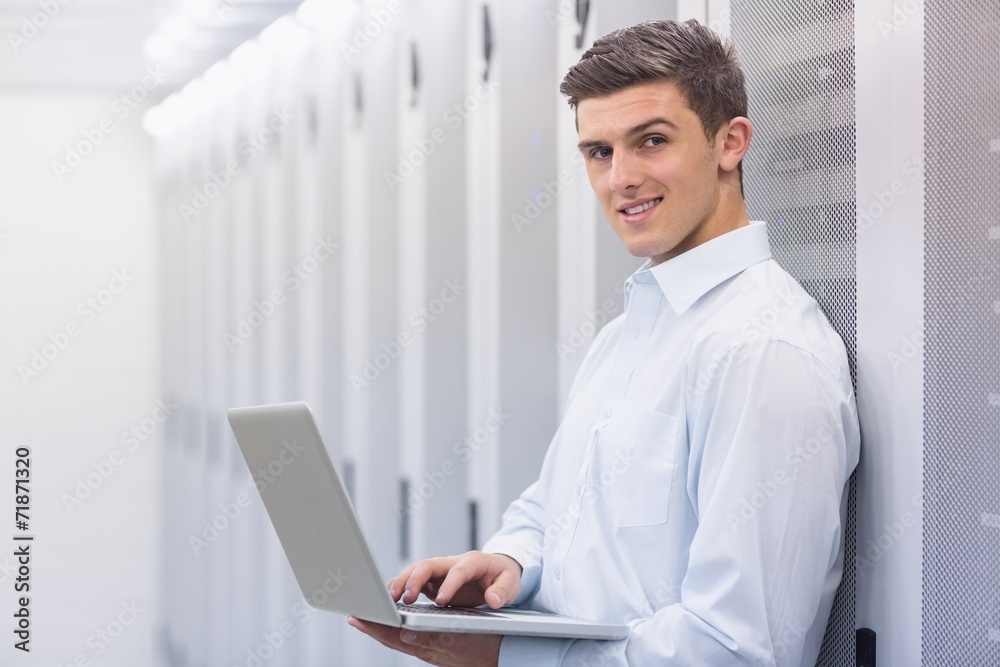 Aufkleber smiling technician typing on his notebook