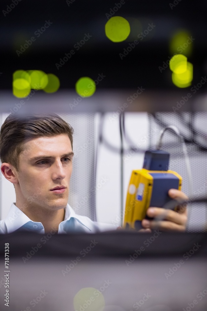 Aufkleber serious technician using digital cable analyzer on server