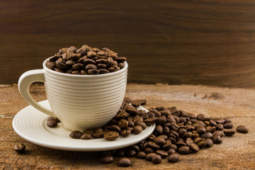 Brown roasted coffee beans in coffee cup.