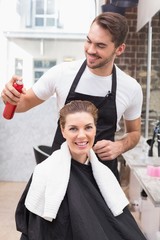 Handsome hair stylist with client