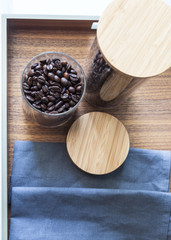 Coffee beans in glass on wood tray