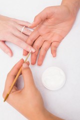 Nail technician giving customer a manicure