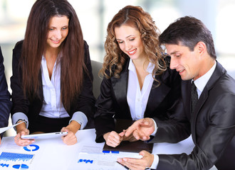 smiling female boss talking to business team