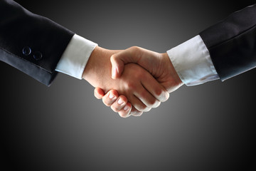 Handshake - Hand holding on black background