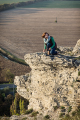 Young woman posing on the high rock