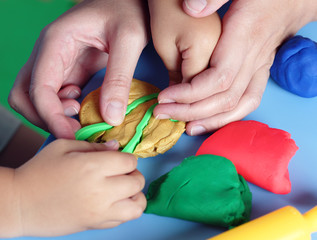 Fototapeta premium Child and mother playing with playdough