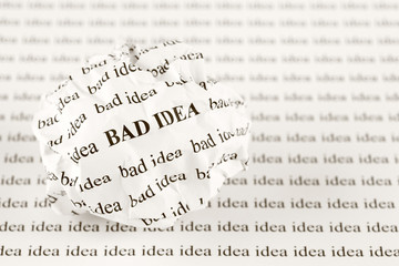 Crumpled paper ball with words bad idea