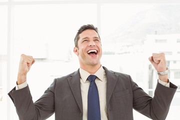 Cheerful businessman cheering in office